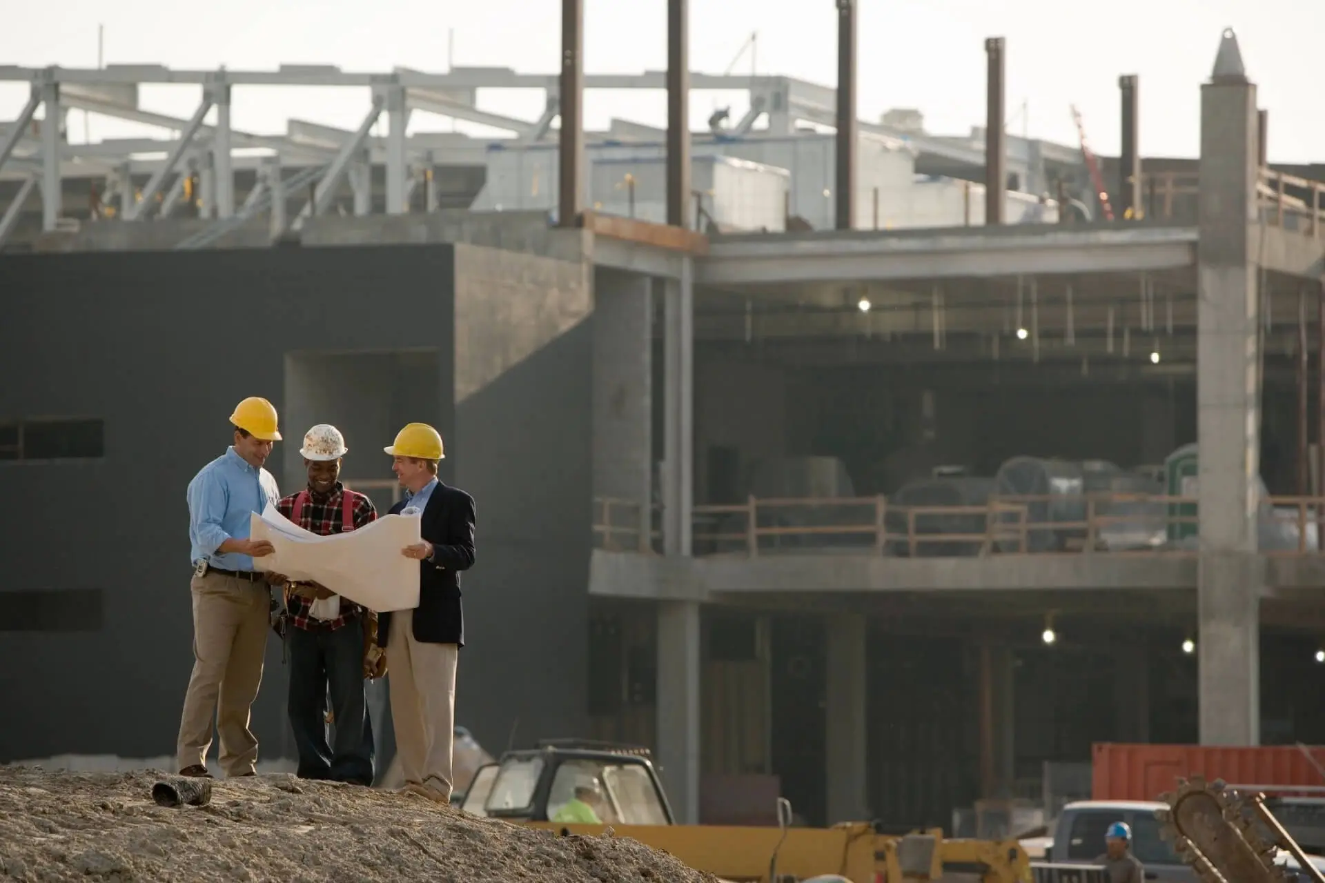 Some workers along with a map working at a site